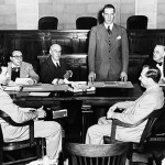 Sen. Estes Kefauver, D-Tenn., standing, chairman of Senate Crime Investigating Commission, opens a one-day hearing in Las Vegas into Las Vegas Gambling Enterprises.    The first witness, William J. Moore, executive director of the Last  Frontier Hotel, is at right foreground.   (AP Photo/Harold P. Matosian)